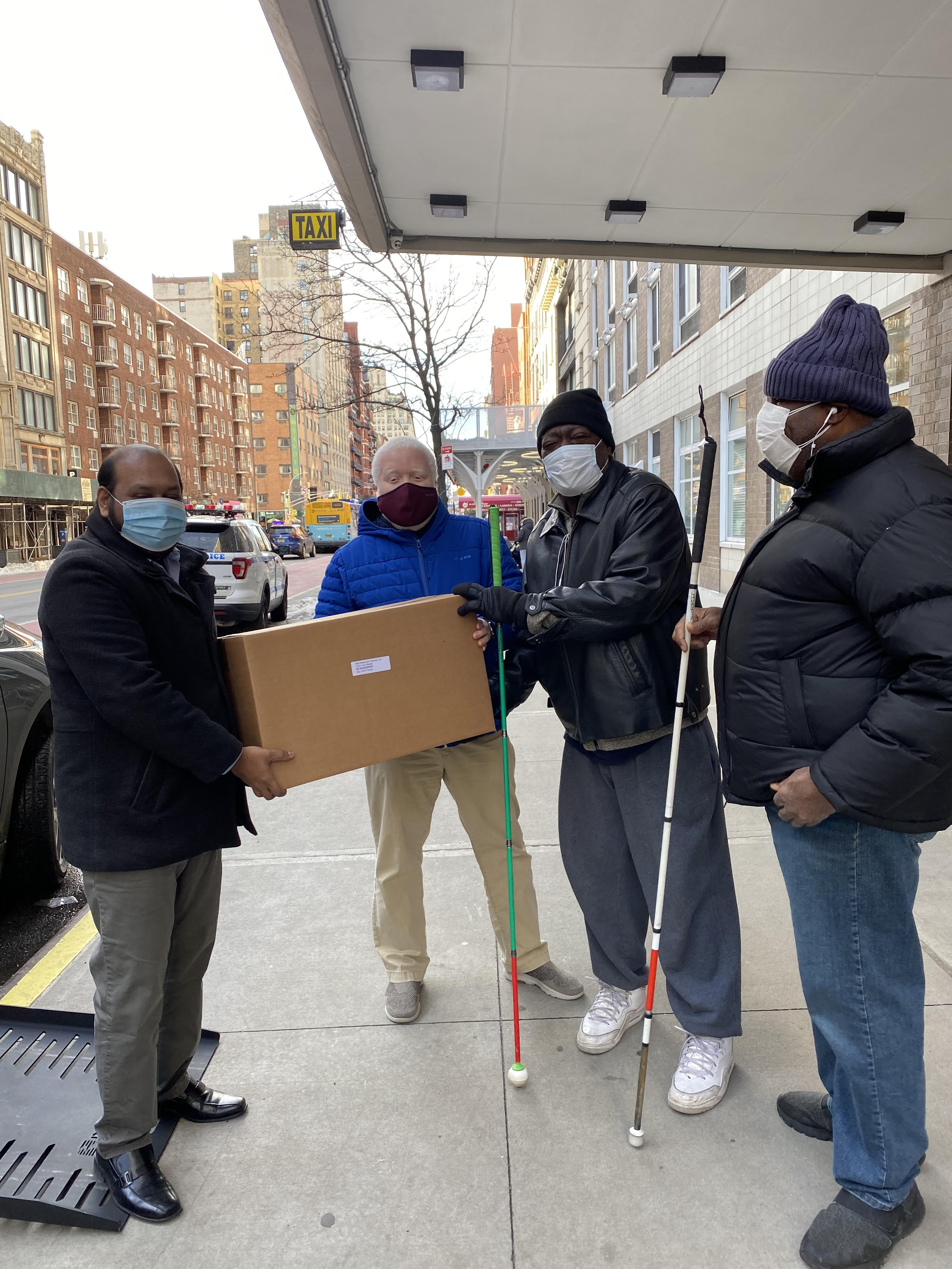 Photo of four men standing outside Selis Manor
